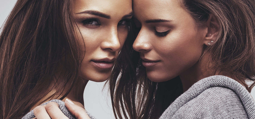 Two women in close embrace with soft expressions and casual clothing, symbolizing intimacy and connection in the context of changing sex toy industry trends.