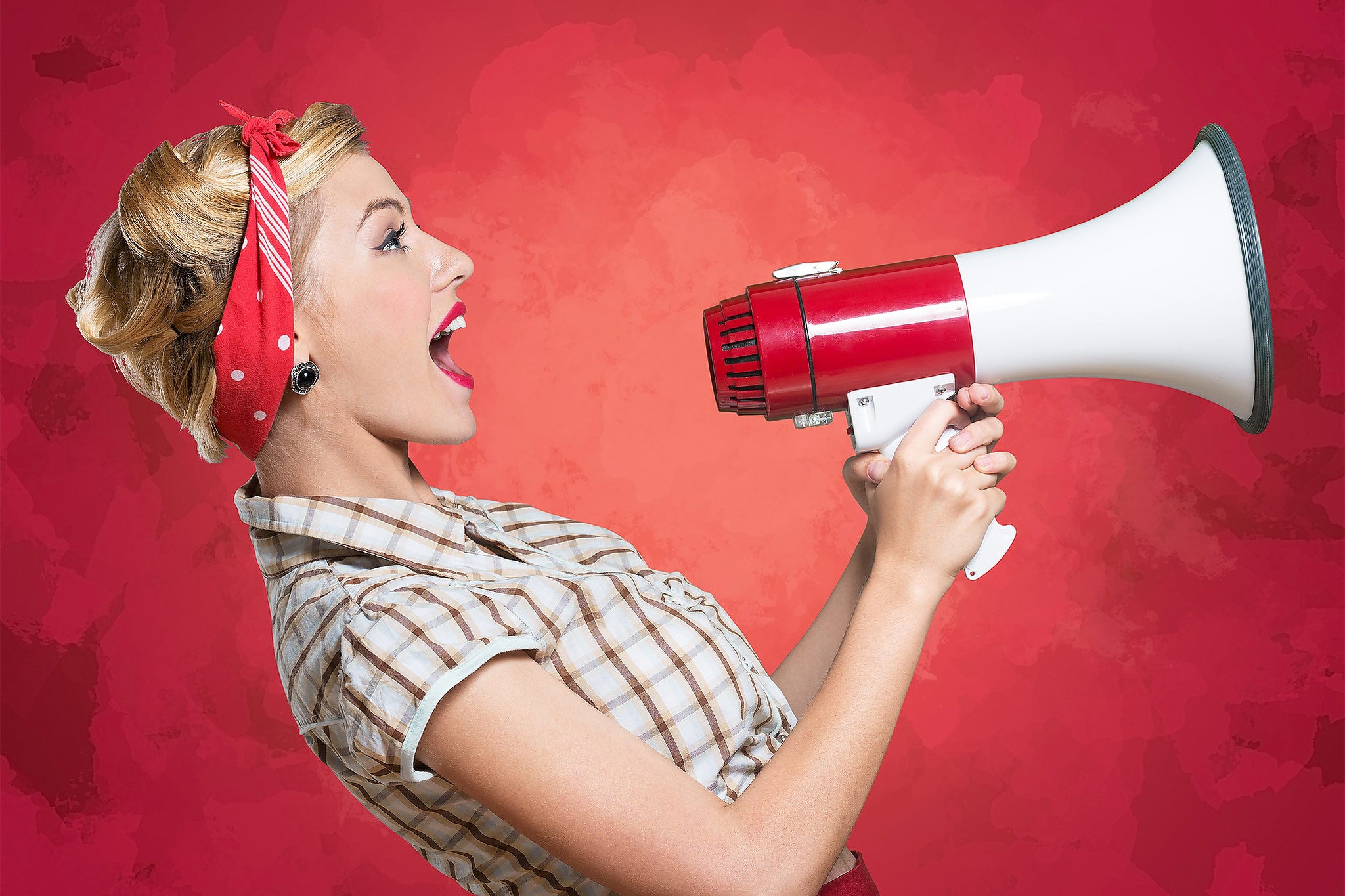 Woman with retro style using megaphone against red background for sex-positivity resources concept