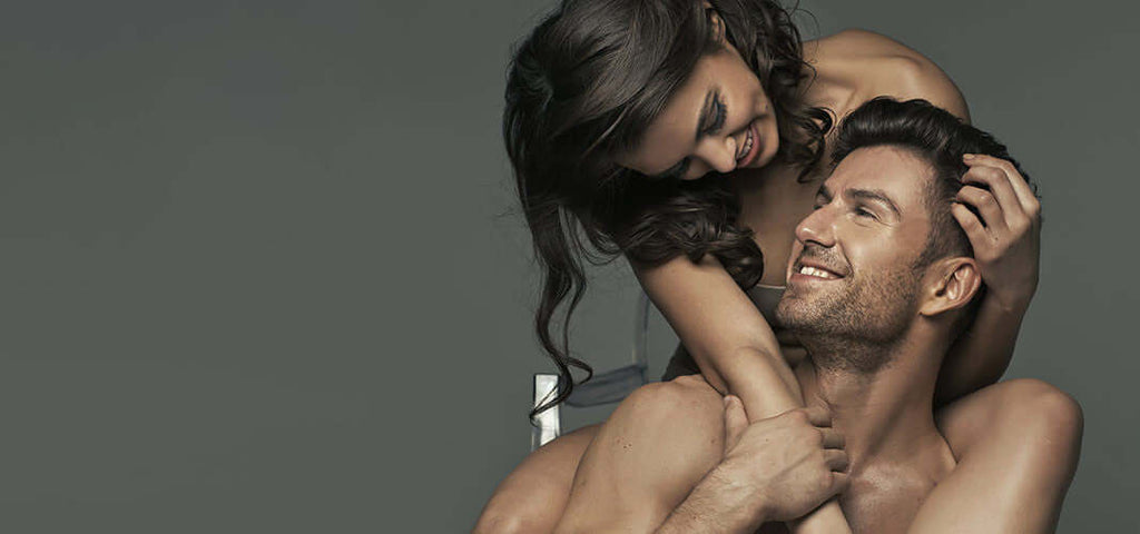 Happy couple embracing sensually, highlighting intimacy and anticipation, promoting tips to buy sex toys as gifts.
