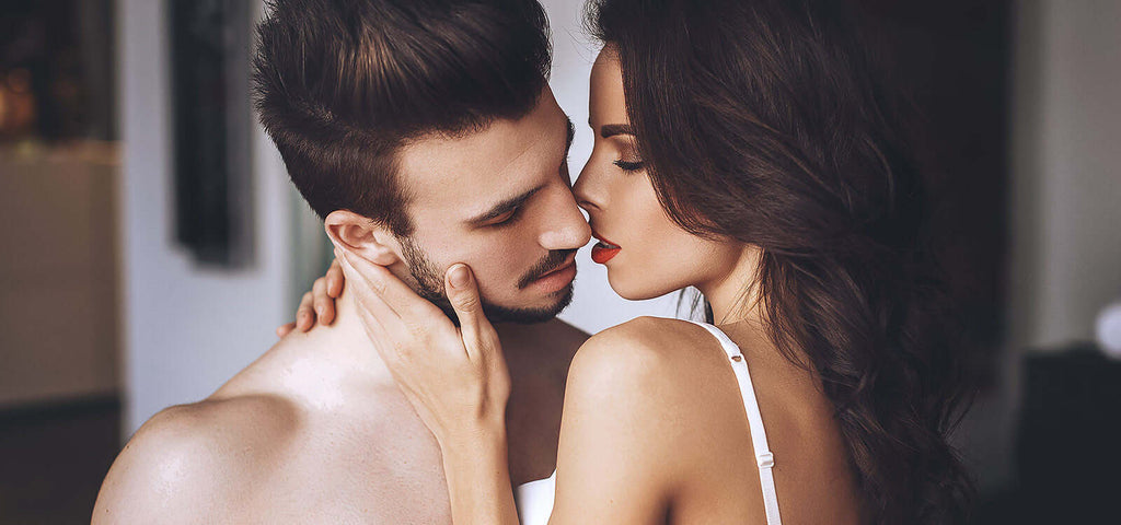 Romantic couple embracing intimately, highlighting the benefits of using lube for a happier, healthier love life.