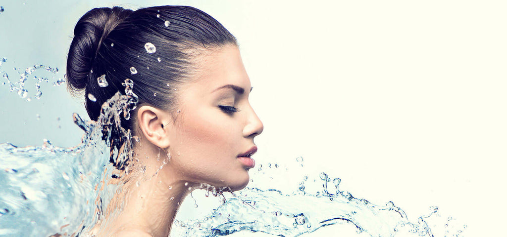 Woman with clear water splash symbolizing hydration and smoothness for personal lubricants product