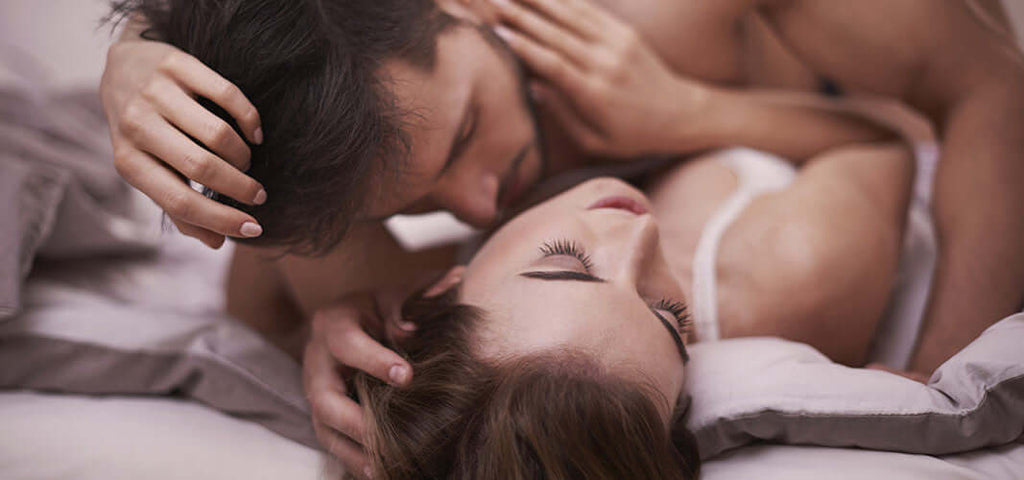 couple sharing intimate moment in bed highlighting quick easy way to enhance your sex life through personal grooming