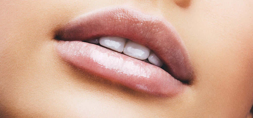 Close-up of glossy, slightly parted lips with smooth skin, symbolizing sensuality related to watching porn benefits
