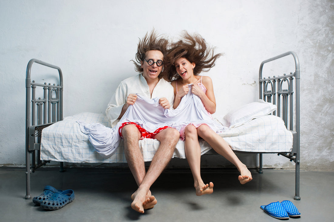 Couple having fun and laughing on bed to bust out of a sex rut