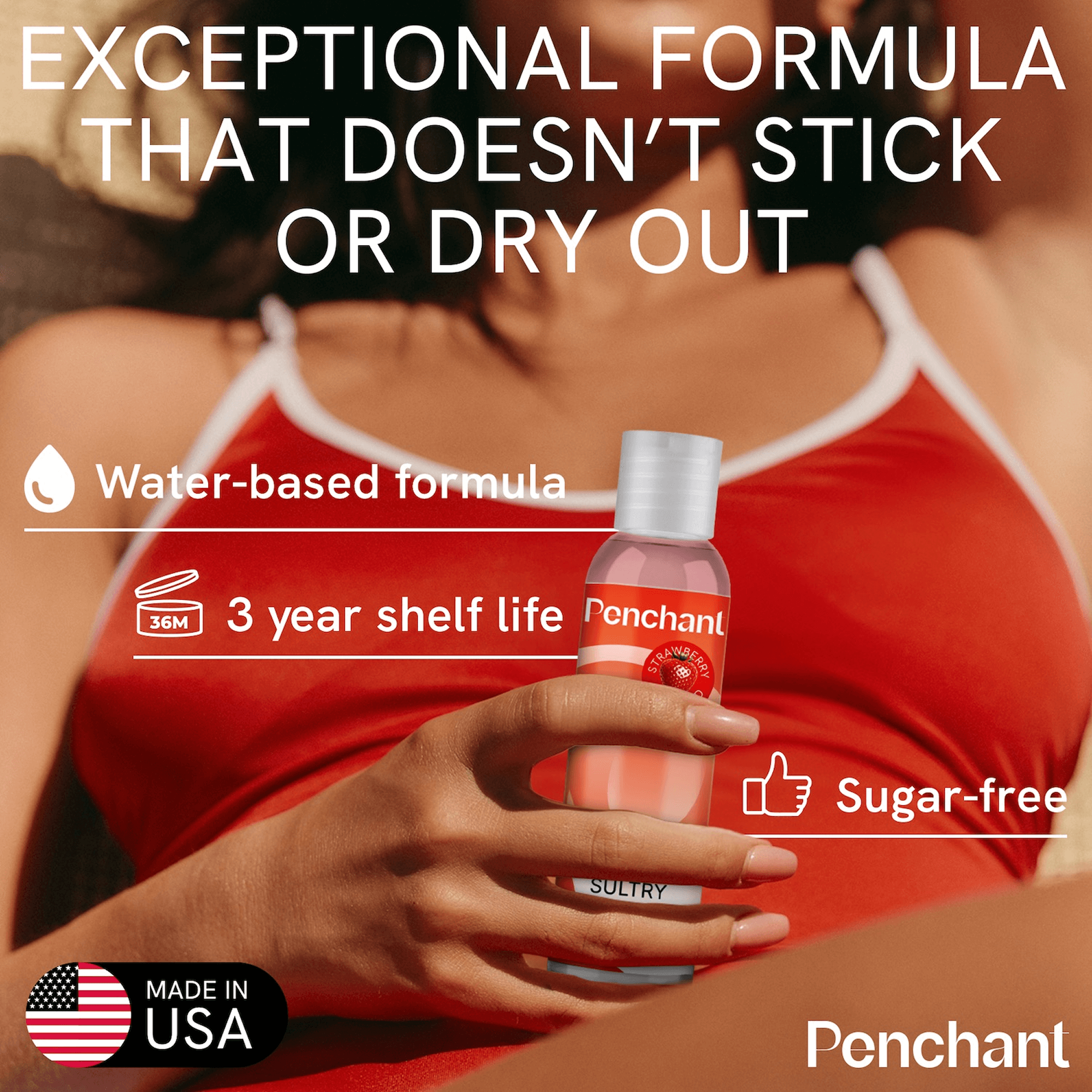 Strawberry Lube bottle held by person with promotional text about non-sticky formula, sugar-free, made in USA.