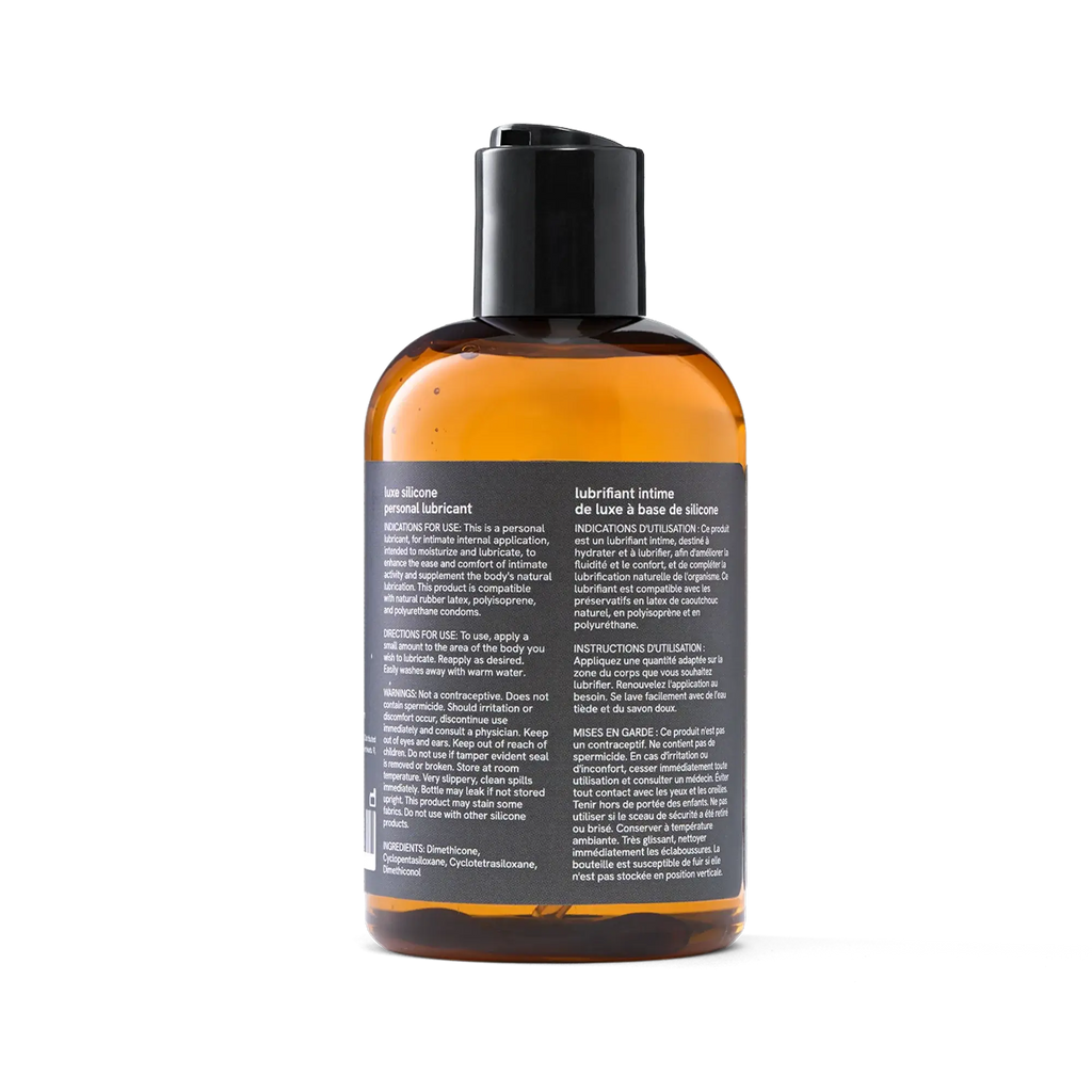 Penchant silicone based personal lubricant bottle back label showing ingredients, directions and bilingual usage instructions, transparent background
