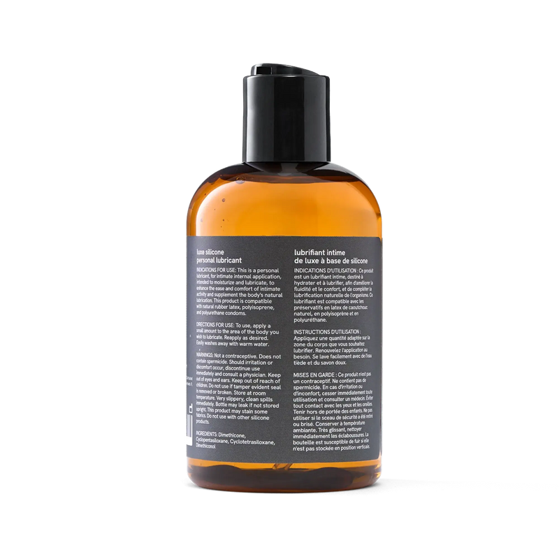 Penchant silicone based personal lubricant bottle back label with bilingual ingredients, directions and usage warnings, transparent background